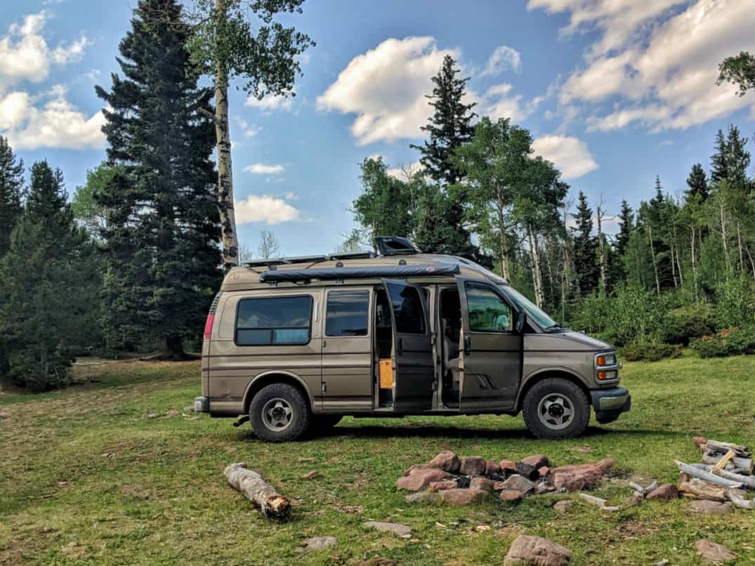 Campervan parked at an awesome camp site in the mountain woodlands of Utah