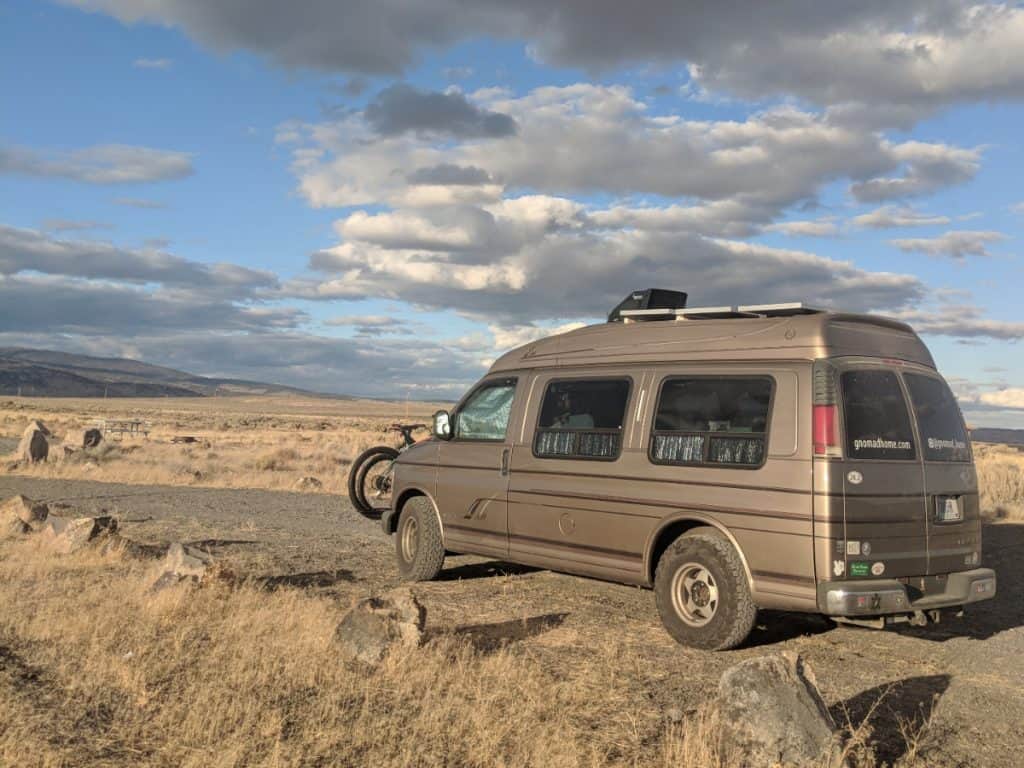 A van is parked under a brilliant sky