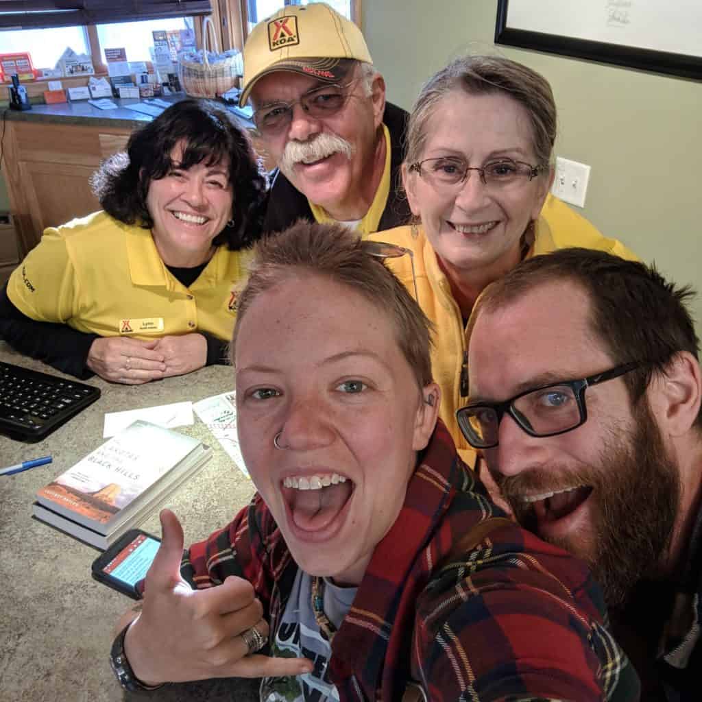 John and Jayme look happy posing with workers at the KOA campground in Rapid City, SD