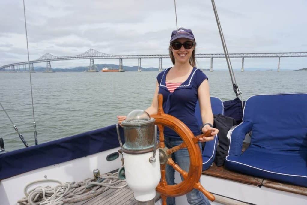 Girl steers her sailboat.