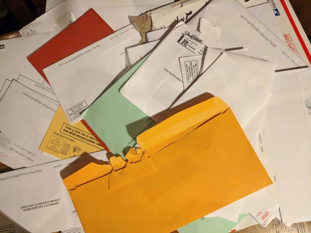 many pieces of mail sprawled out on a table