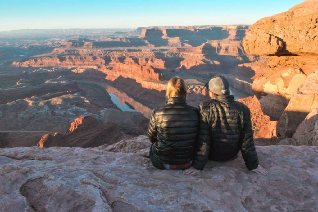 Guy and girl overlook the Grand Canyon.