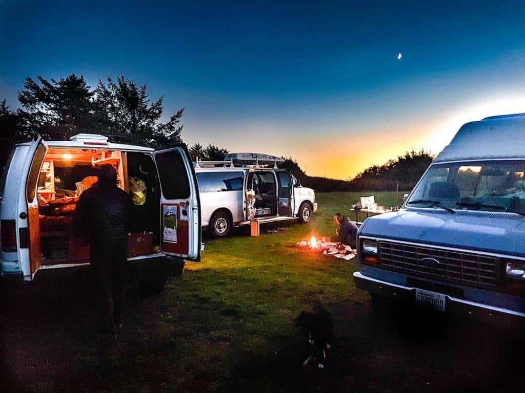 Three vans camped out together in the woods