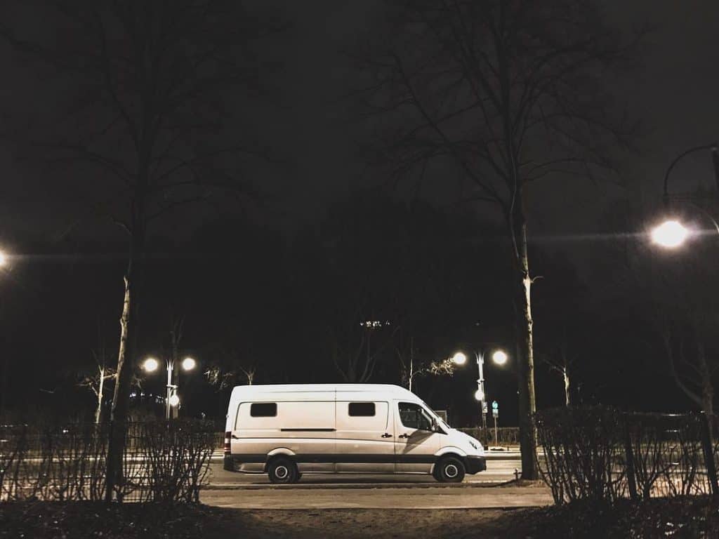 Van parked on city street at night