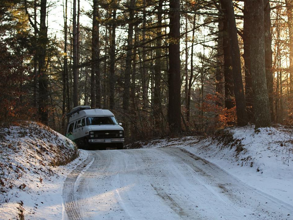 Van driving down snowy road