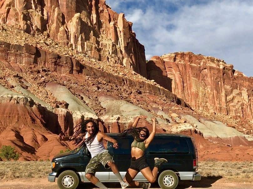 blak couple dancing in front of chevy in red rocks