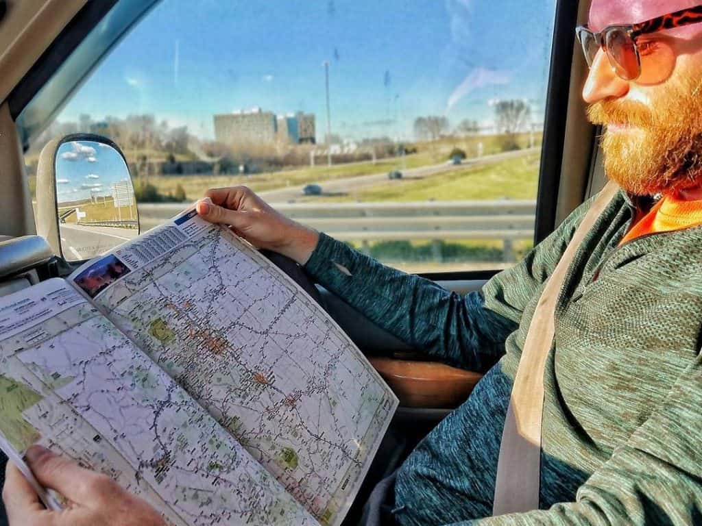 man reading map in passenger seat