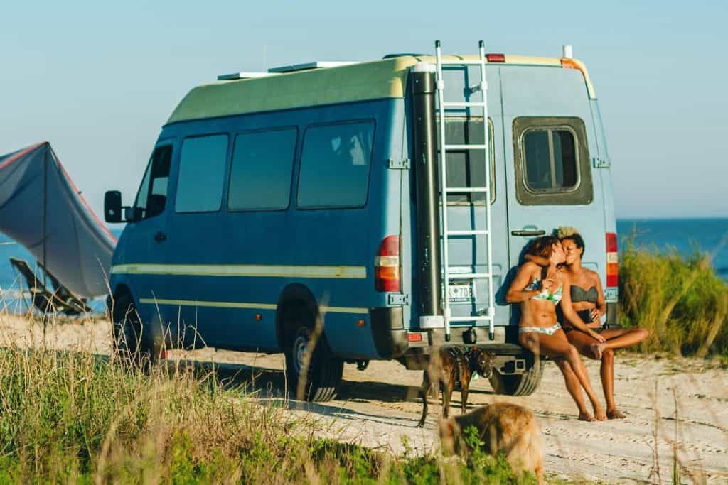 two girls kissing on sprinter tailgate