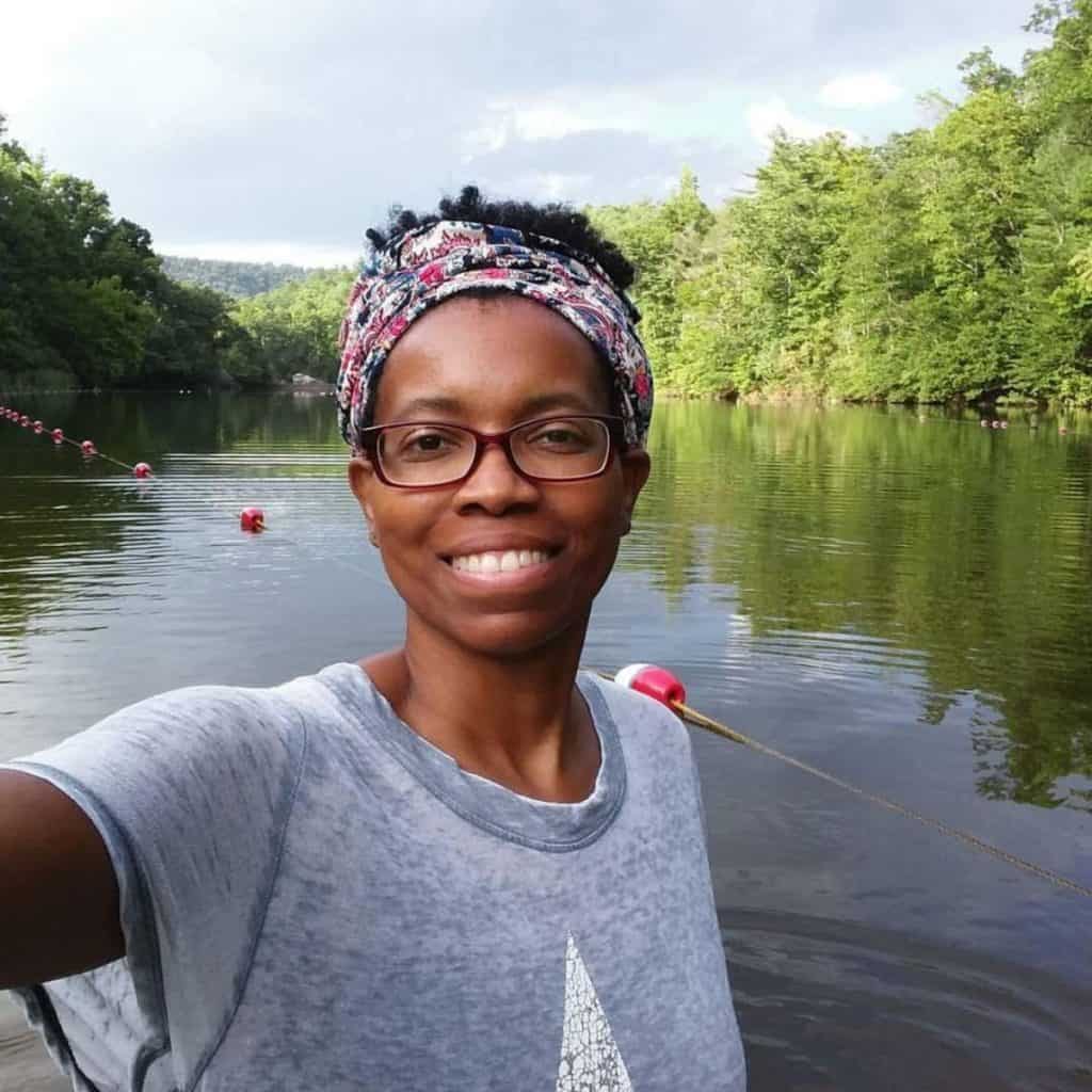 Crystal poses with a body of water behind her