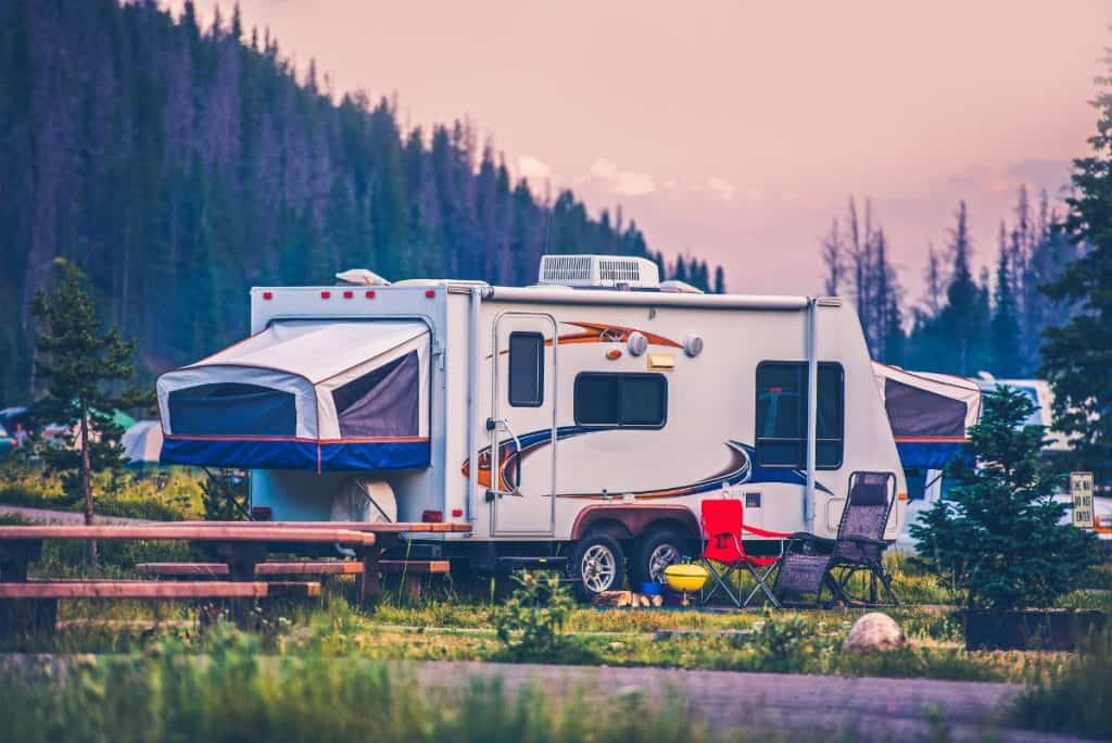 pop up trailer parked in a meadow