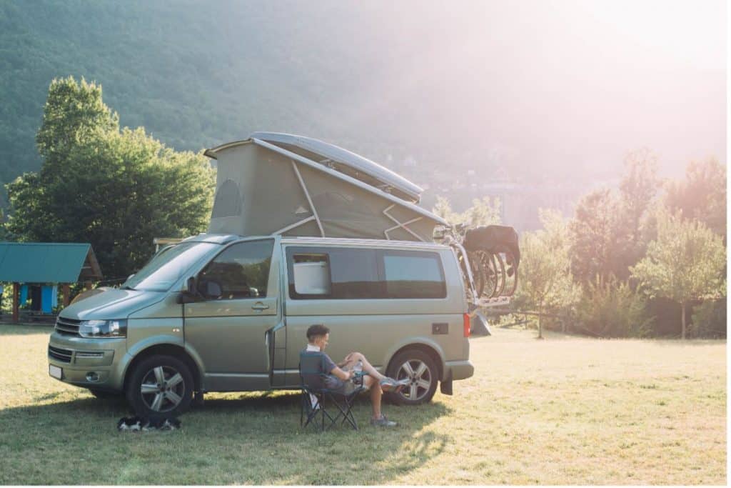 person chilling in a chair outside their campervan