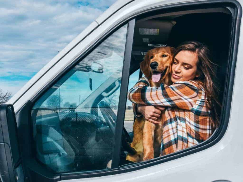 Sydney sits in the driver seat holding Ella.