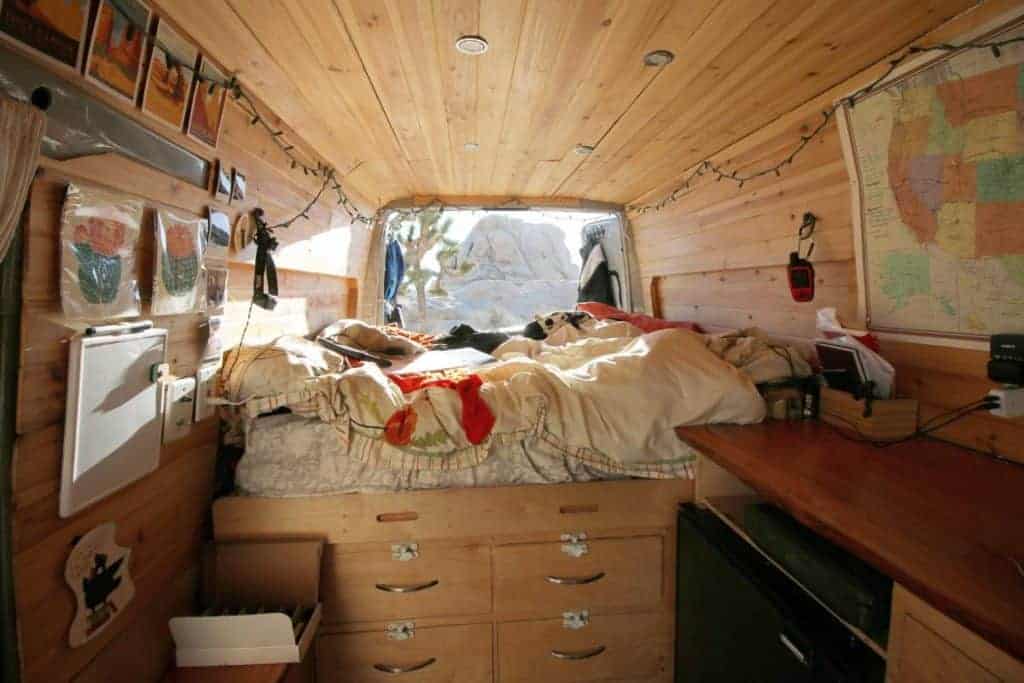 A view of the interior back section of the van showcasing Kaya's bed.