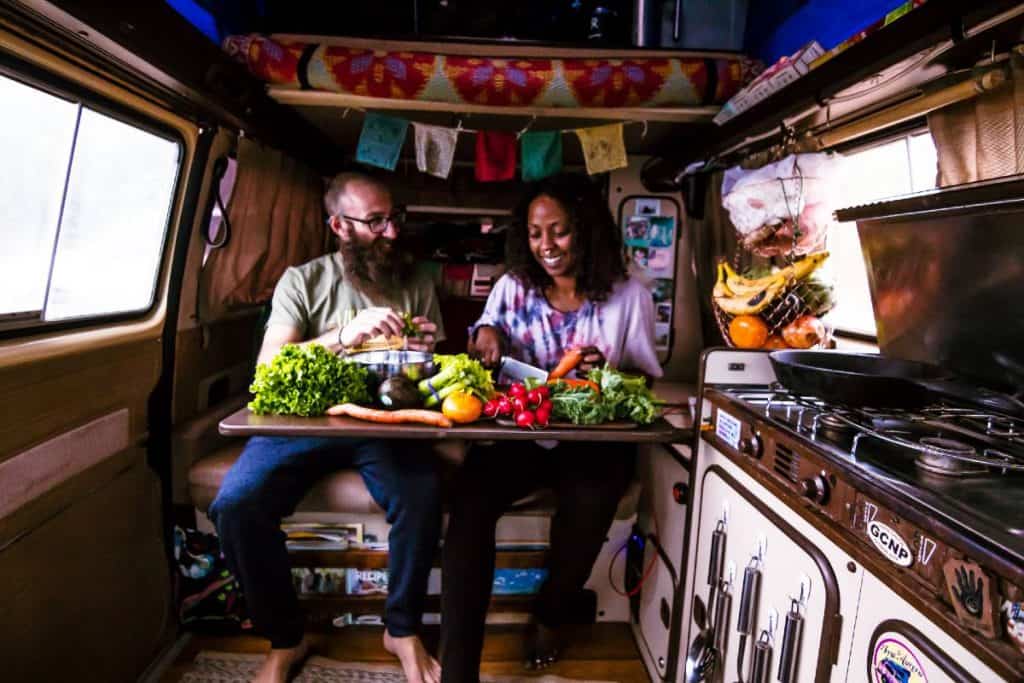 Dustin in Noami in the van surrounded by veggies.