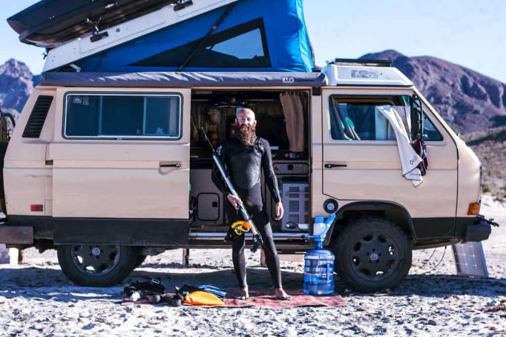 Dustin poses in front of the van fishing equipment.