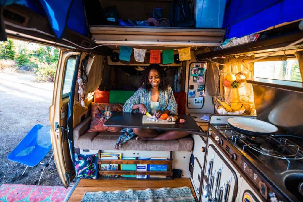 Noami preps food in the van.