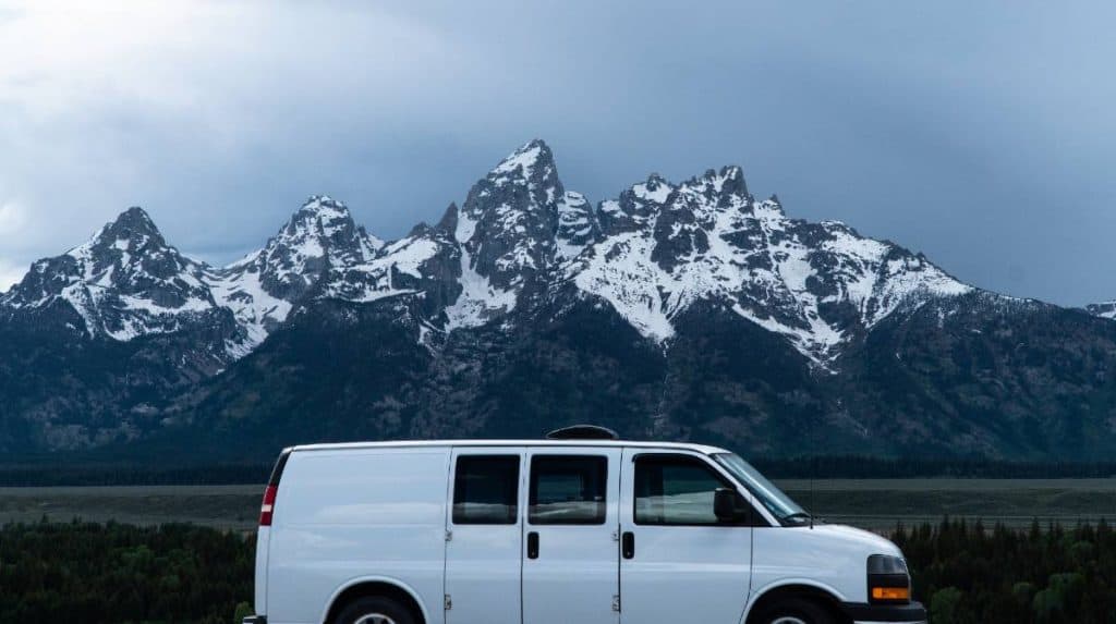 The van parked in front of the Grand Tetons.