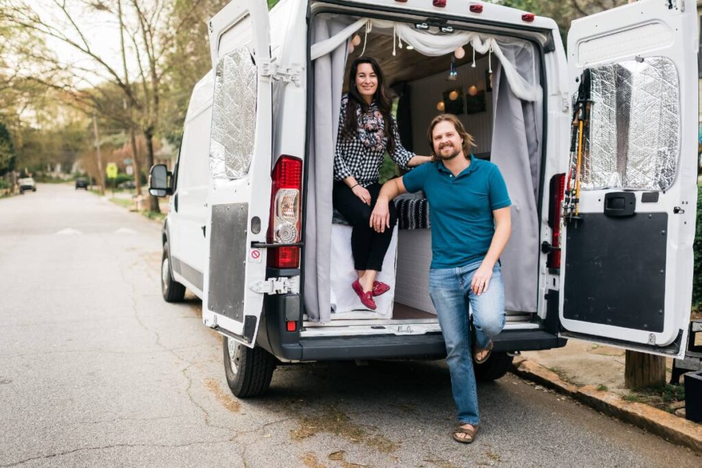 Van couple posing by their dodge ram promaster