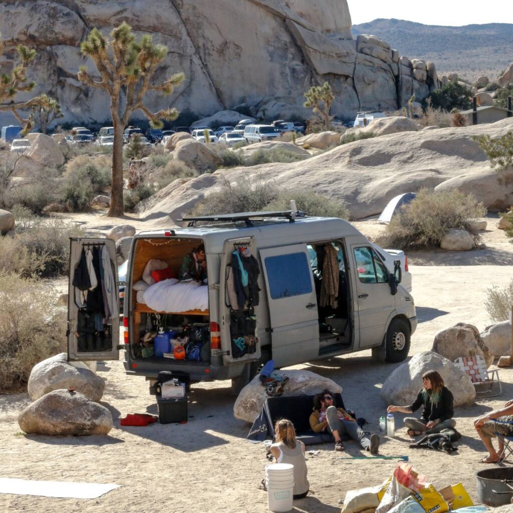 sprinter van parked among the rocks near joshua tree