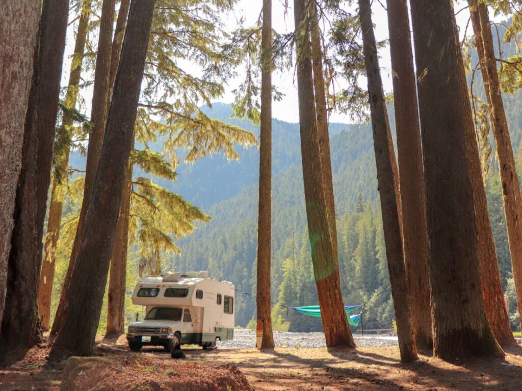 Toyota rv parked in the trees by a lake