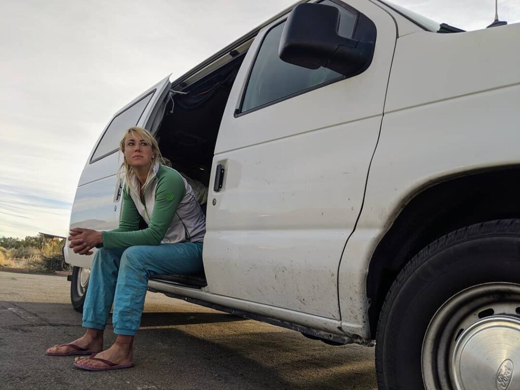 Pro rock climber sitting in her van