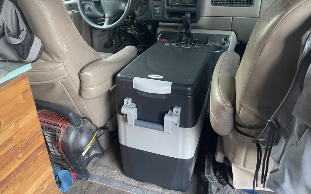 BougeRV refrigerator between the front seats of van