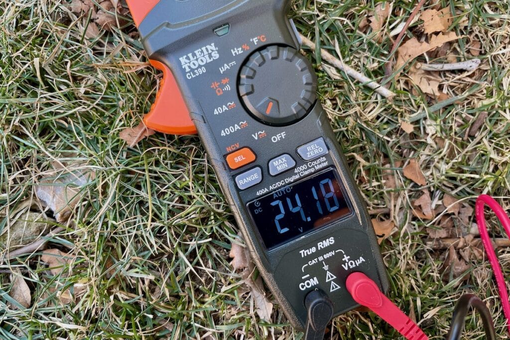 Multimeter testing solar panel voltage