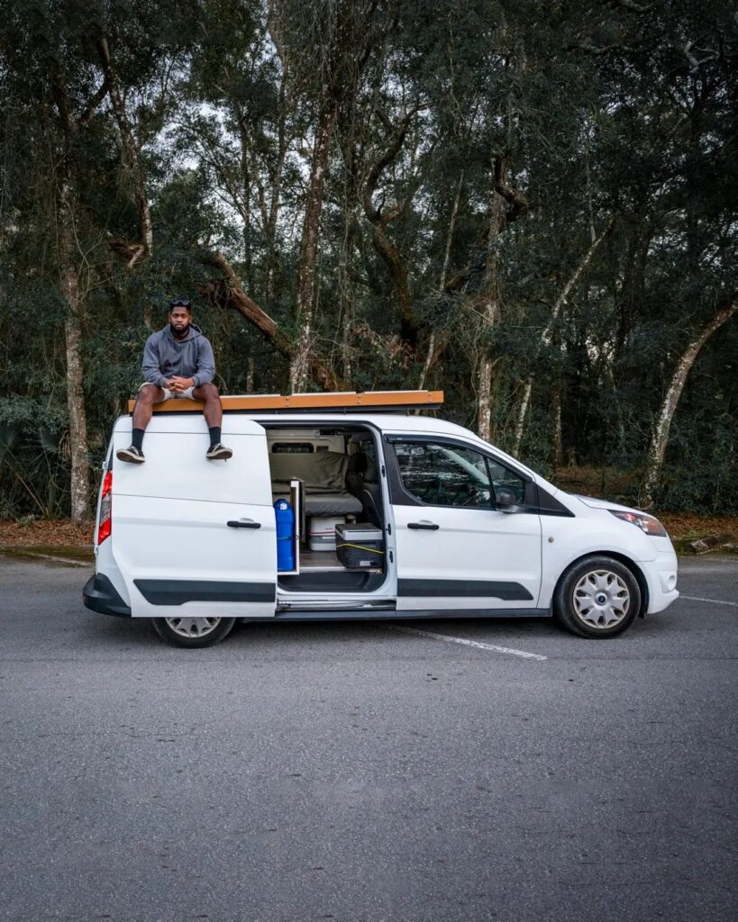 @alainmaven Man sitting on top of his ford transit camper van