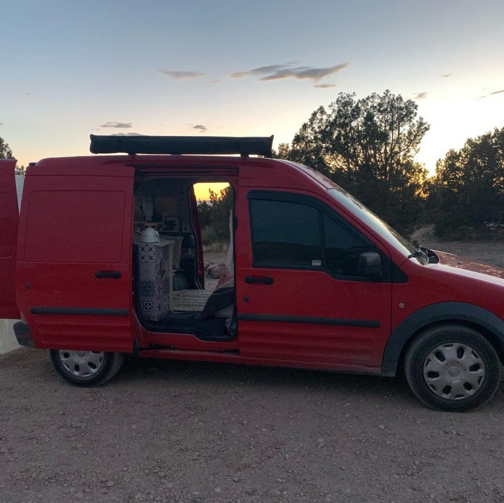 @ladybug.out Red transit connect camper van parked on countryside road