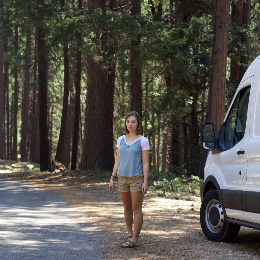 @mariahthewind_ woman standing near a ford camper van