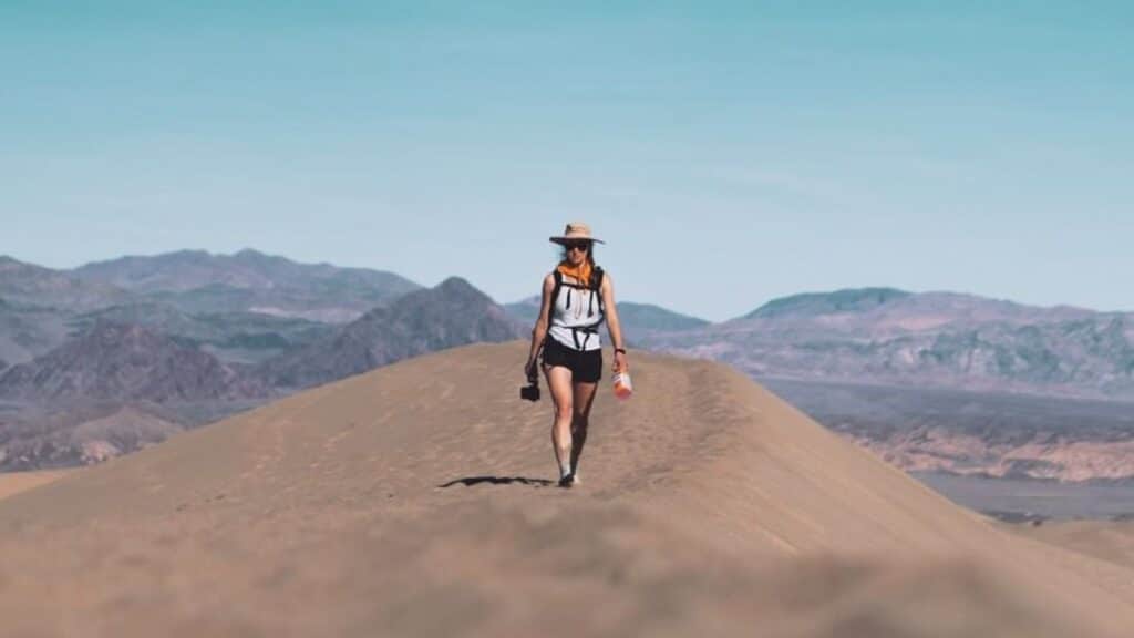 @murphy_mobile_ Woman wearing a hat walking on top of a mountain, van life