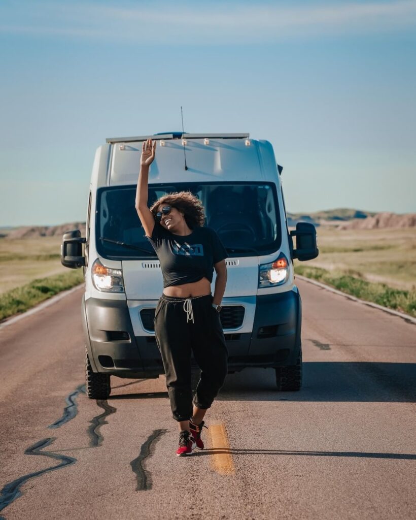 @antoinetteyvonne Woman and her promaster camper van parked in the middle of a deserted road