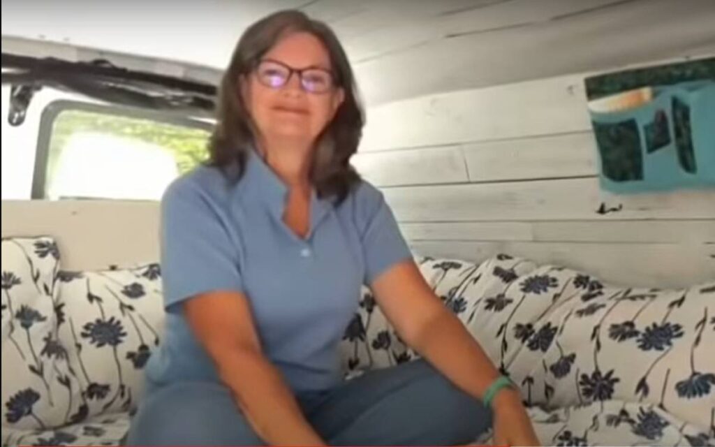 @kyoungtravels Woman sitting on a bed inside a camper van