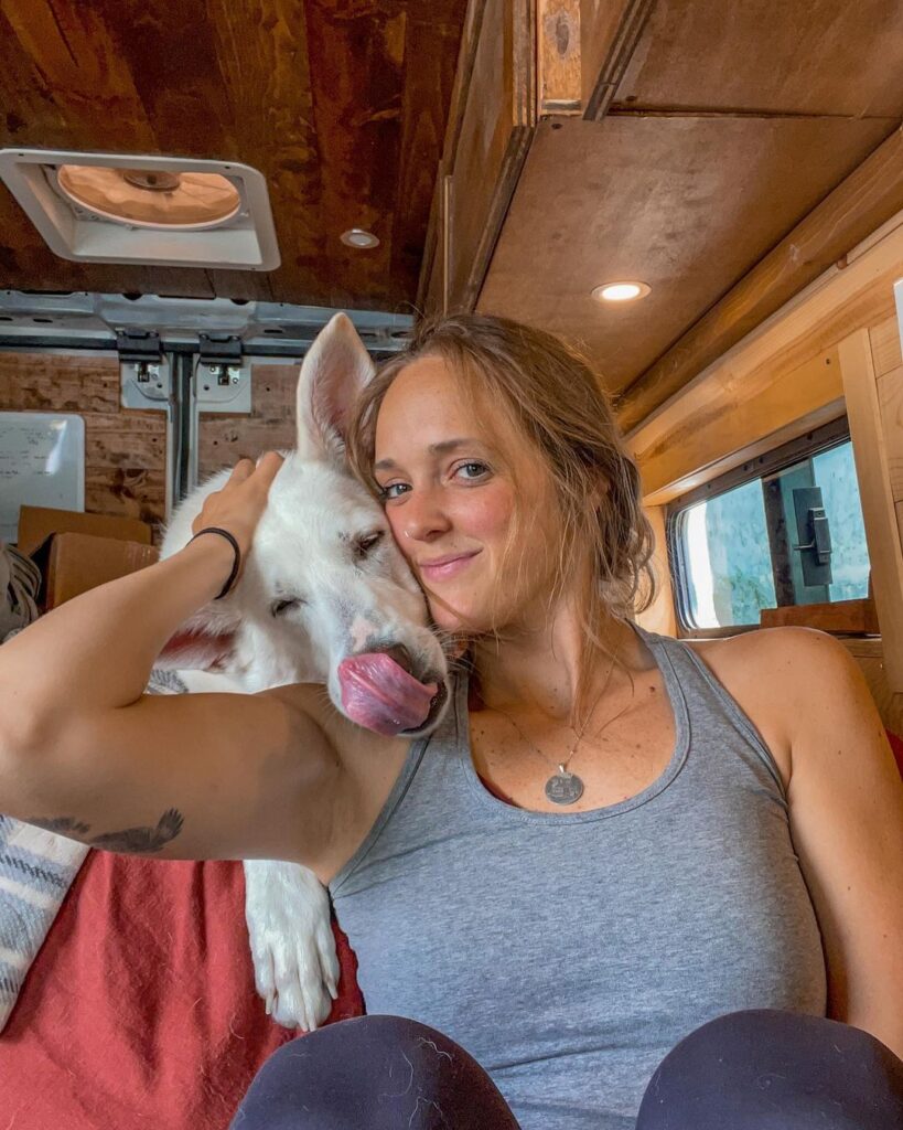 @linnea.and.akela Woman and her dog in ram promaster camper van