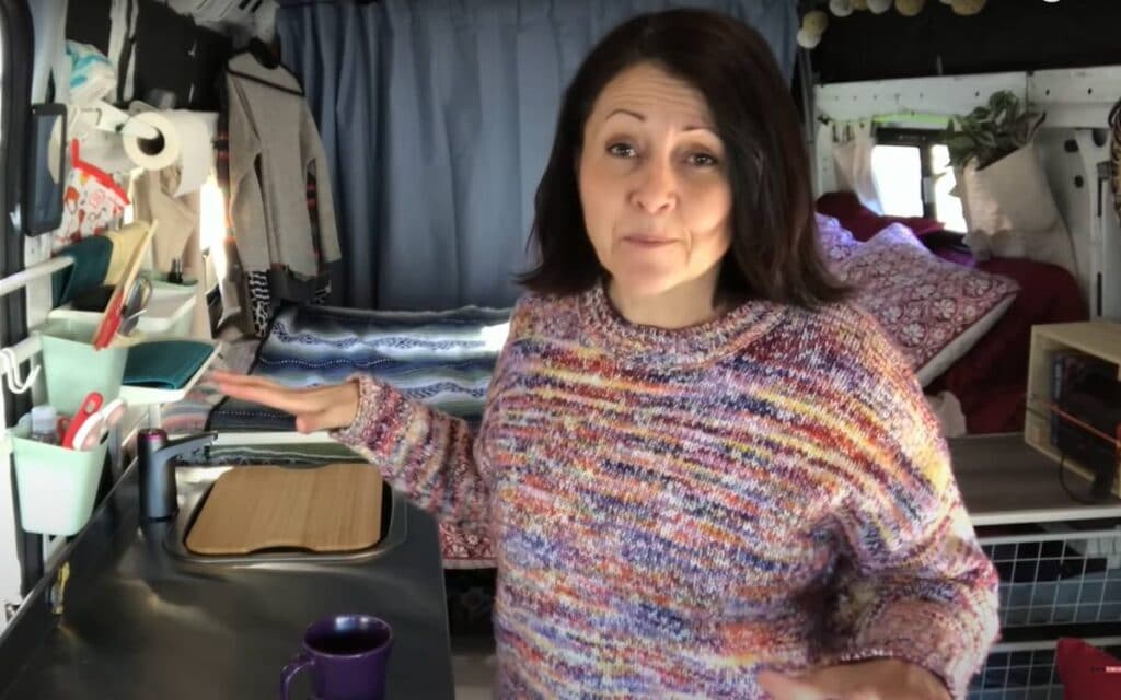 @mybigtinyhouselife Woman showing the interior of her ram camper van