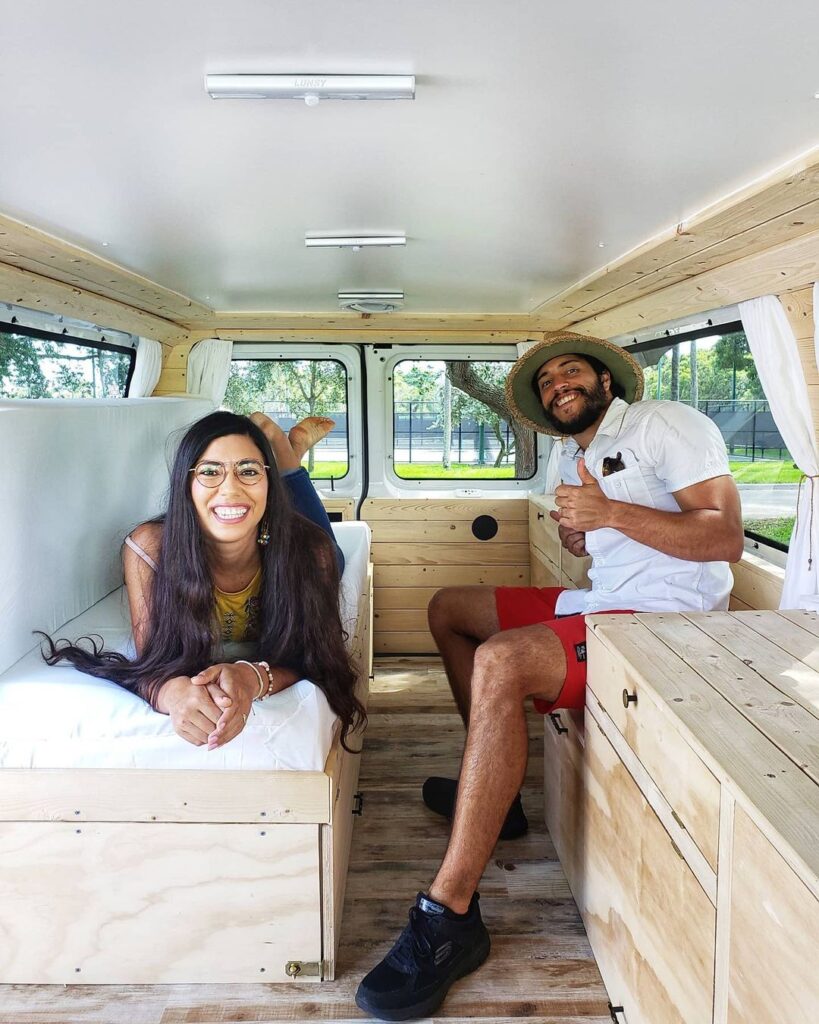 @r.m.travels man and woman inside a chevy express camper van
