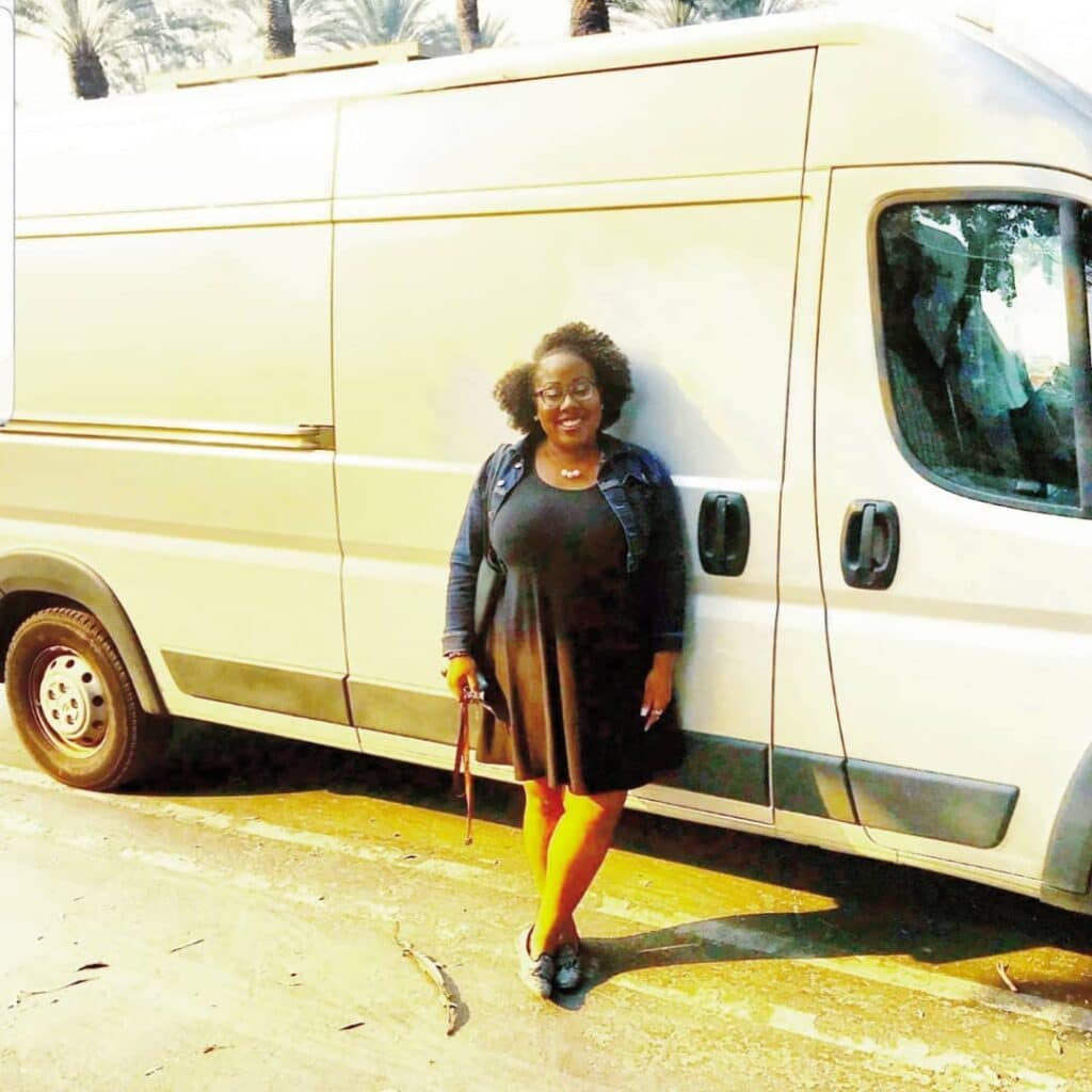 @rolling_resilience Woman standing next to a ram promaster camper van