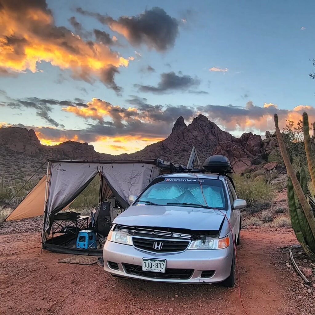 @jay.moyes Mini van camper parked in a desert area with mountain view