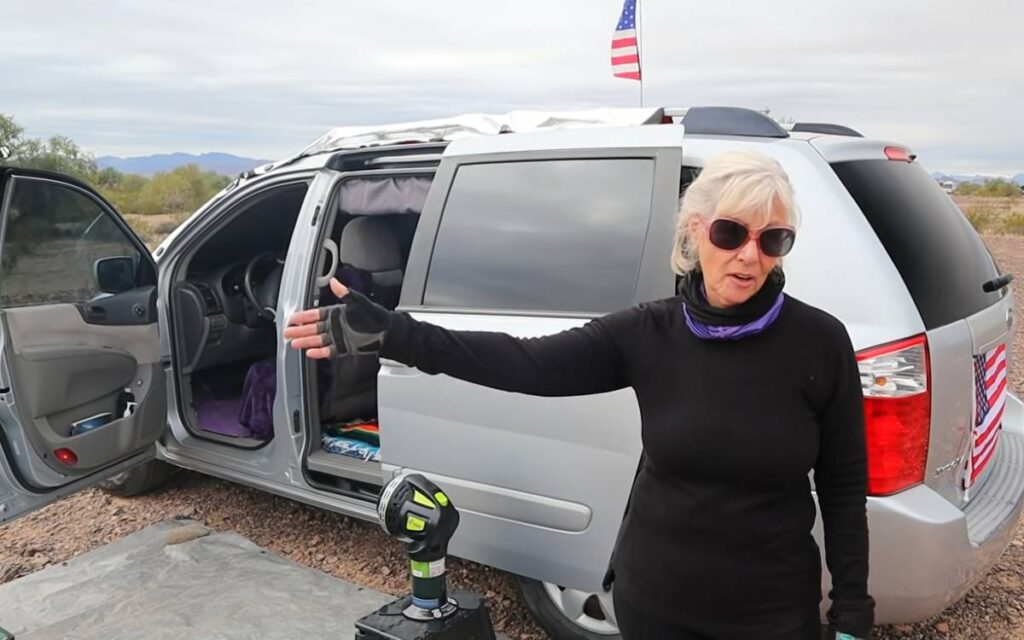 @minivan_lee standing next to her mini van camper