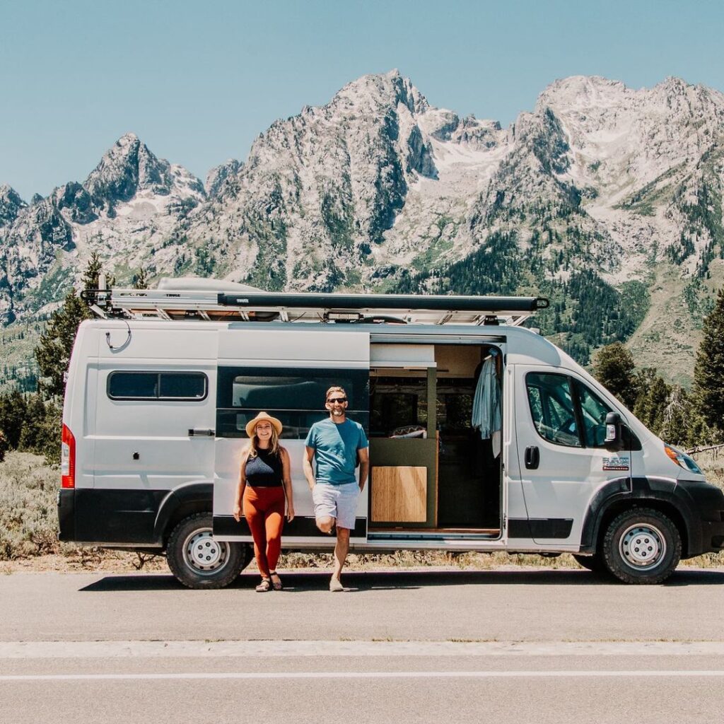 @vanhalla_adventures Couple standing against camper van