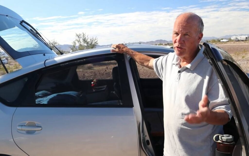 David showing his Toyota Prius car converted to a camper