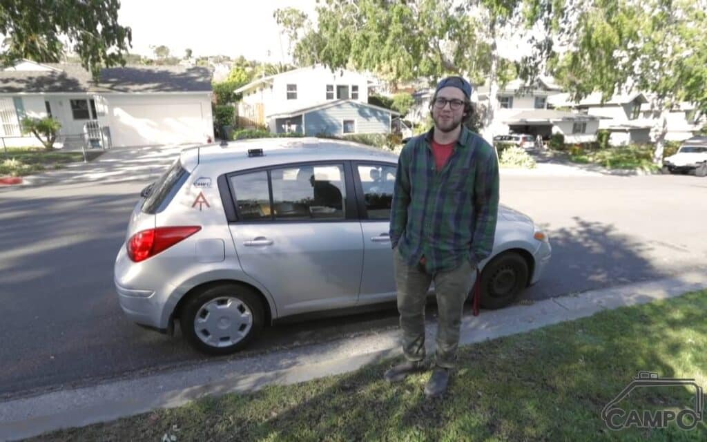 Joey next to his camper car parked on the side of the road