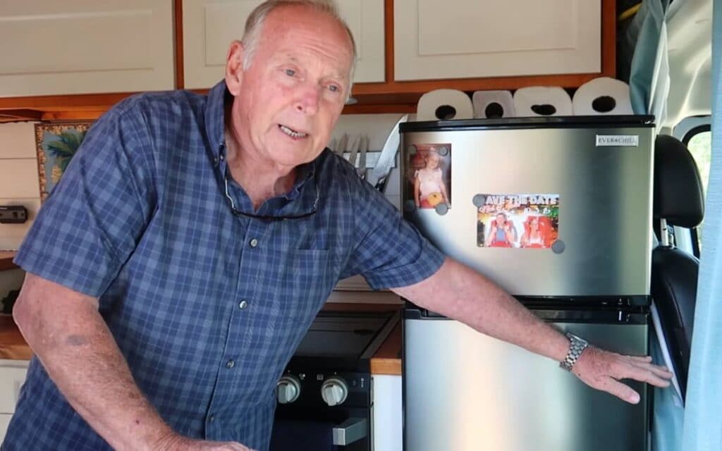 John showing the fridge in his ram camper van