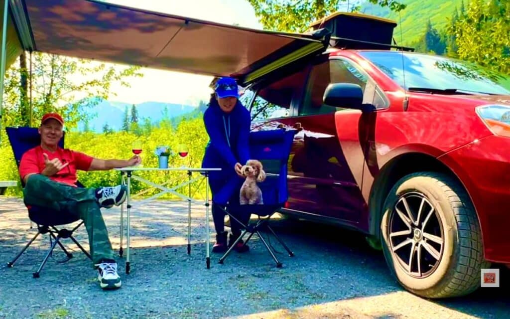 Mitchell and Bonnie camping in a minivan rv with their dog