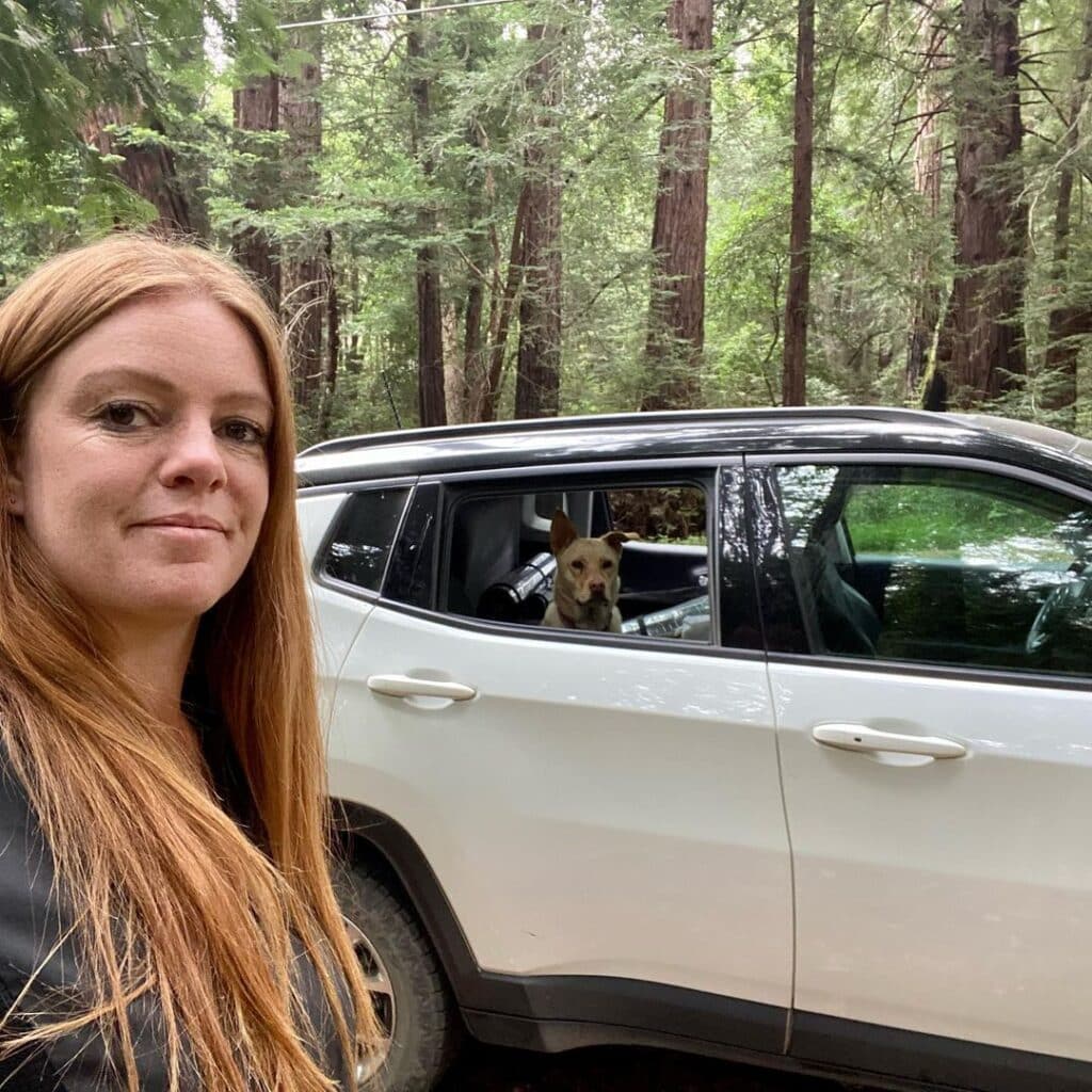 @citygirlunplugged Woman next to her suv camper with a dog sitting inside
