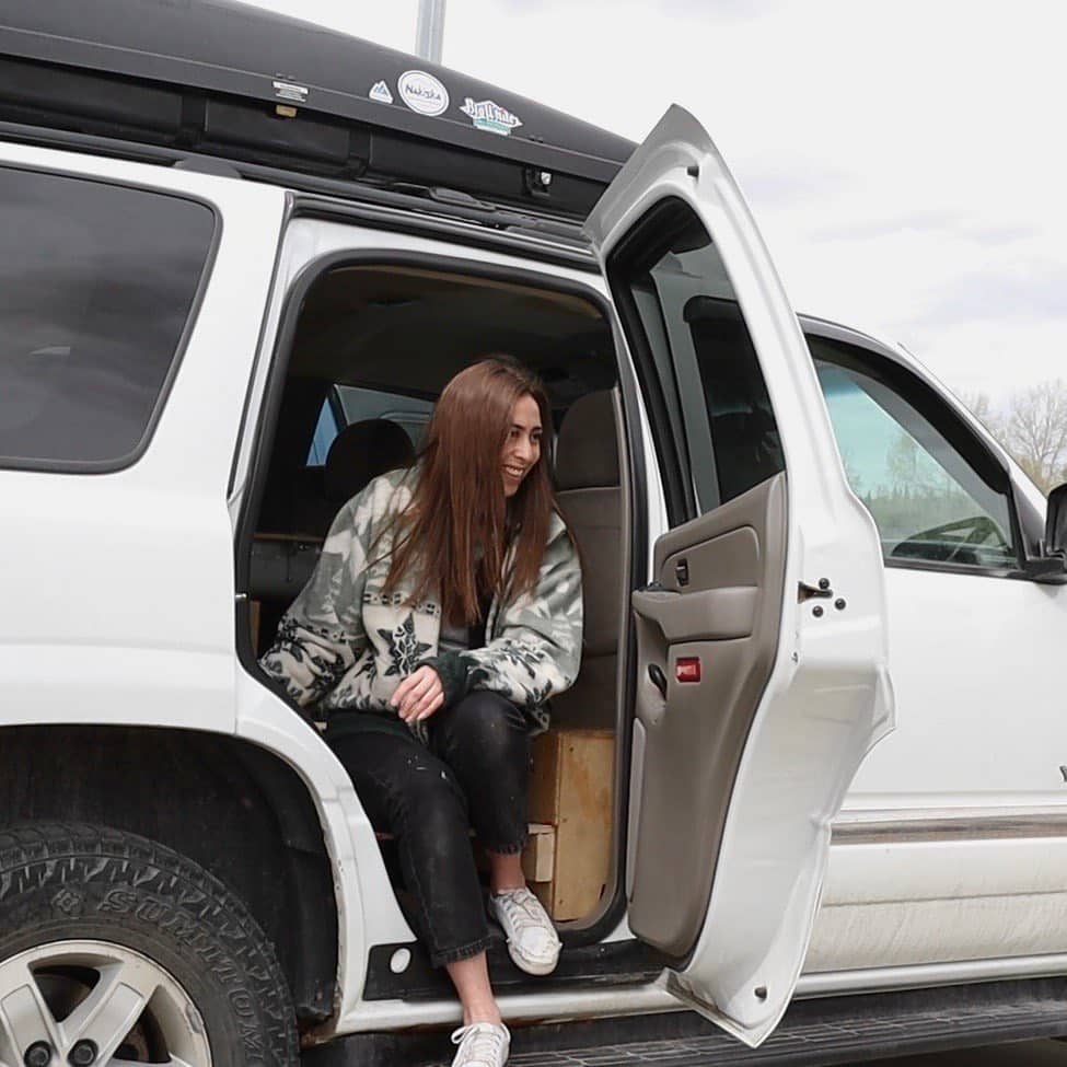@meganclaarke Woman stepping out of her white suv car camper