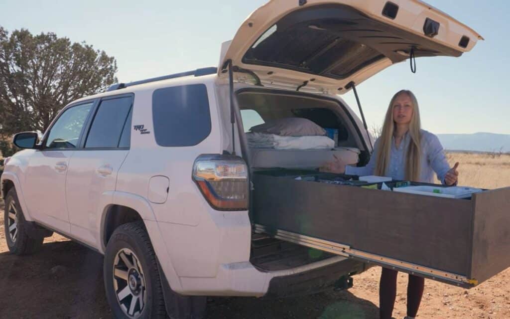 https://gnomadhome.com/wp-content/uploads/2022/08/@noperfectplan-suv-camper-with-a-long-drawer-at-the-back-1024x640.jpg