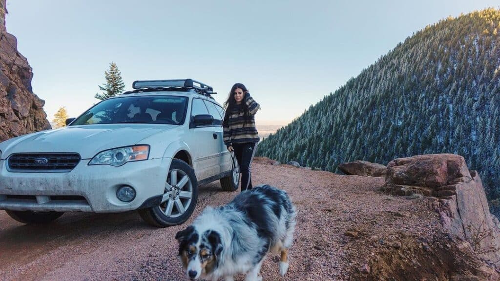 @roamingreckless suv car camper parked on unpaved road