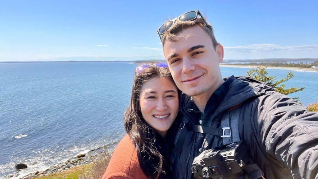 @romanandjulia Couple camping at the beach in their suv car camper