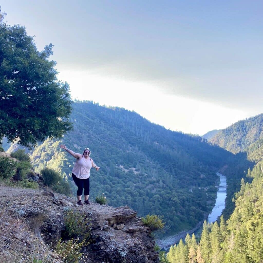 @sarockinthebox suv camper woman standing on a cliff